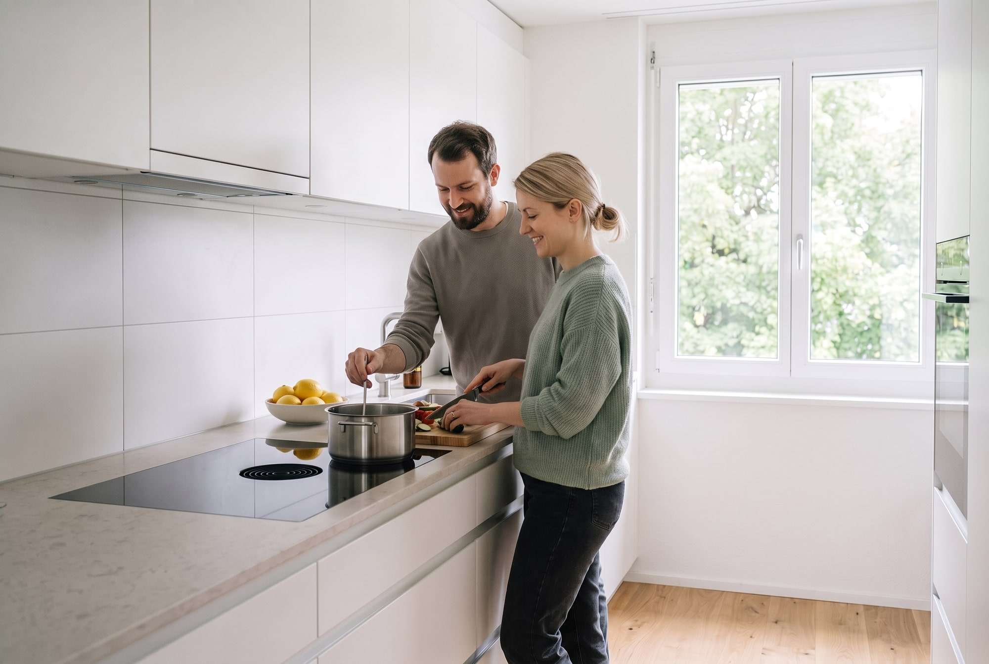 Paar kocht gemeinsam in einer hellen Küche